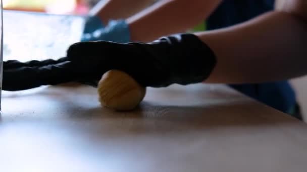 Women hands in gloves knead the dough — Stock Video