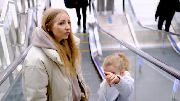 Anne ve kızı asansörle istasyon binasına çıkıyorlar. — Stok video