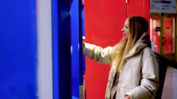 Junge lächelnde Frau in Jacke kauft Zug- oder U-Bahn-Fahrkarte — Stockvideo