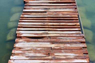 Old wooden bridge through the sea bay