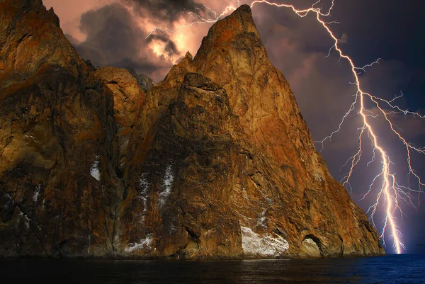 Karadeniz kıyısındaki Koktebel yakınlarında kayalıklar üzerinde fırtına ve şimşek çakıyor. Parlaklık ve drama