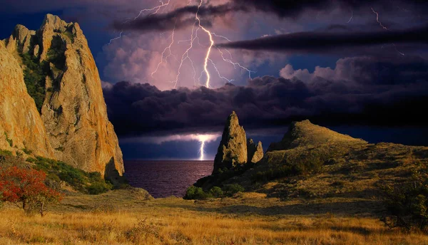 Karadağ 'ın kayalarının üzerinde şimşek çakıyor. Karadeniz kıyısı, Doğu Kırım, dağlarda çarpıcı bir fırtına manzarası, yıldırımlar ve parıltılarla