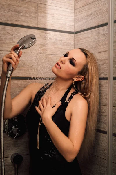 Young beautiful woman sitting wet in the shower — Stock Photo, Image