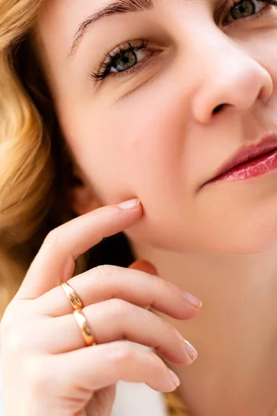 Part of a womans face with a hand near her cheek — Stock Photo, Image