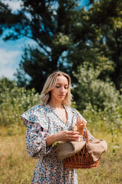 Genç ve güzel bir kız elinde ördek yavrusuyla bir sepet tutuyor.