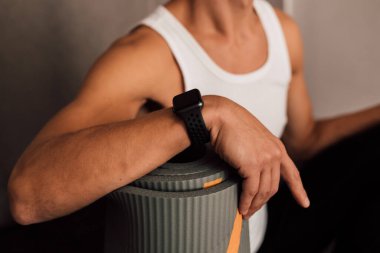 A mans hand rests on a mat for sports training