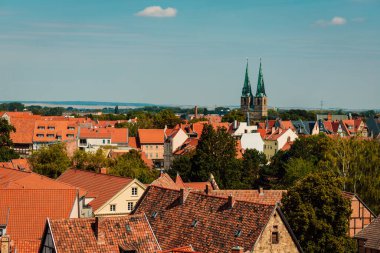 Red roofs of beautiful houses. Top view. Beautiful architecture of the old town. Blue beautiful sky.
