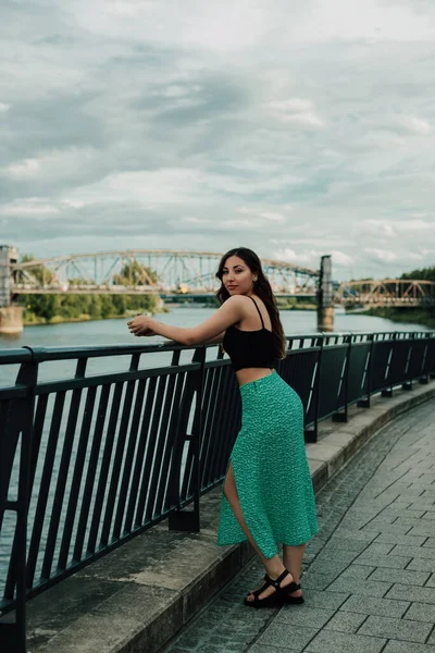Woman Leans Bridge Looks Camera She Dressed Shirt Skirt Warm — Stock Photo, Image