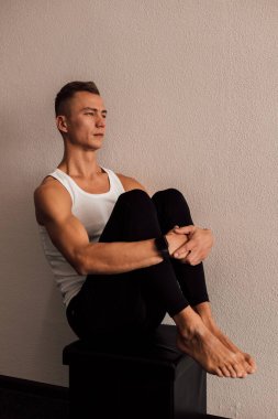 Genç bir sporcu spor yaparken bir fitbol topuna oturur. Spor Yoga Zindeliği. Yüksek kalite fotoğraf