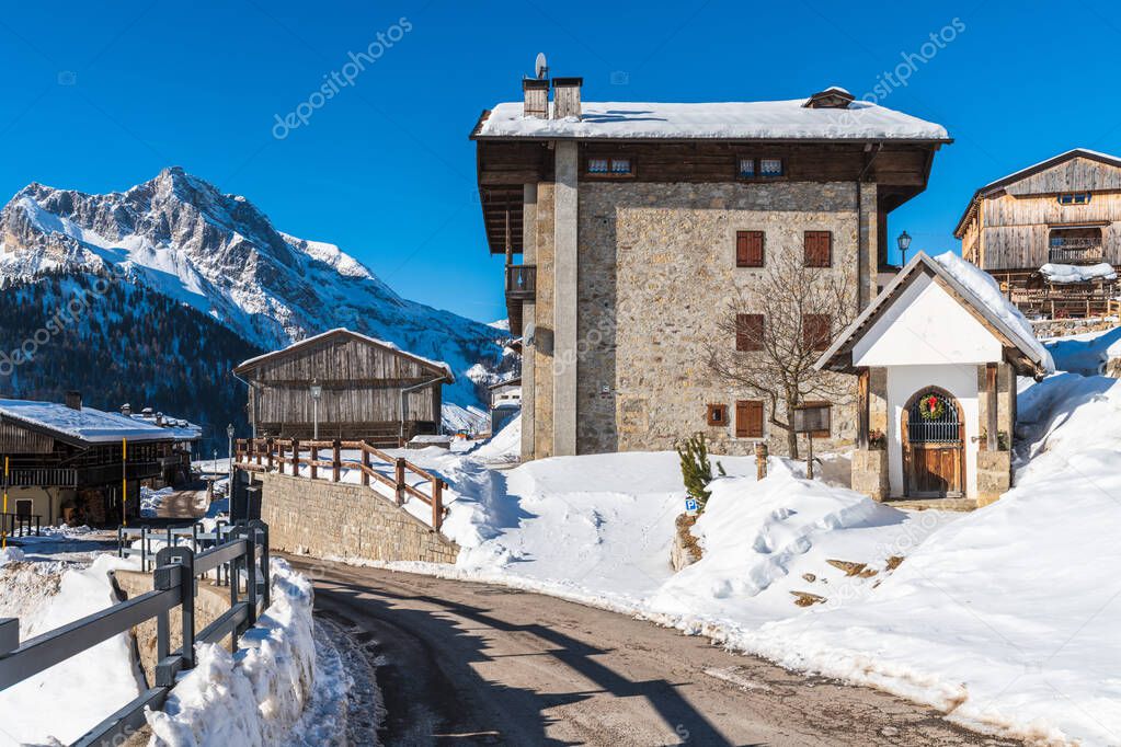 beautiful winter landscape with snowy mountains and village cottages. View of Sauris commune in the Province of Udine in the Italian region Friuli-Venezia Giulia. 