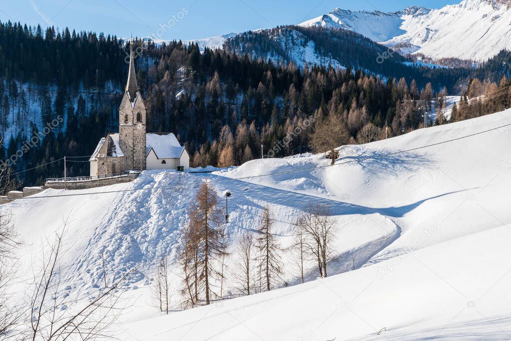 San Lorenzo church in Sauris di Sopra. Beautiful winter landscape