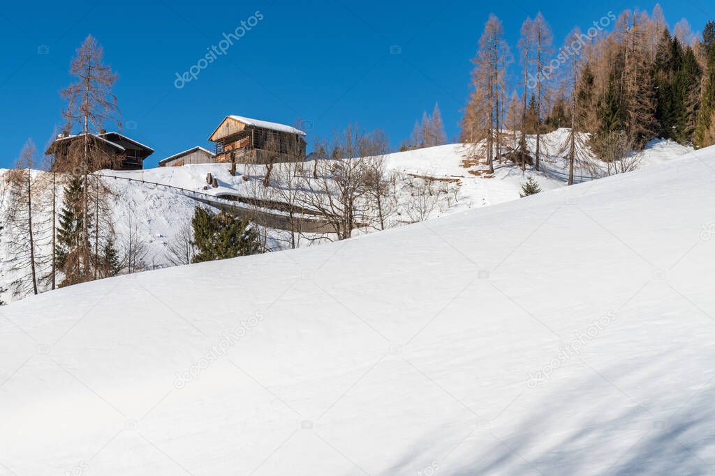 beautiful winter landscape with snowy mountains. View of Sauris commune in the Province of Udine in the Italian region Friuli-Venezia Giulia. Sauris is situated within the Carnia mountain area of Friuli, in the Lumiei Valley of the Carnic Alps.