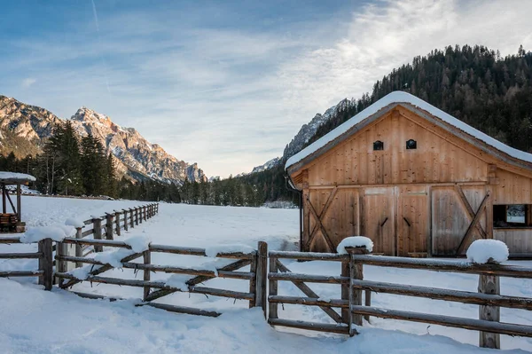 winter landscape with wooden barn