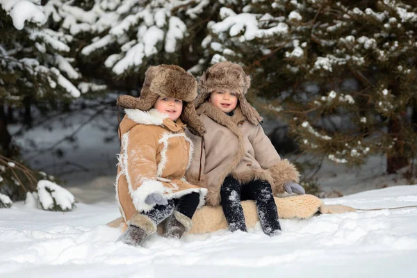 Two cute kids in winter Russian folk clothes like in a fairy tale