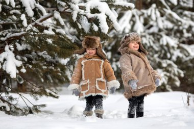 Two cute kids in winter Russian folk clothes like in a fairy tale clipart
