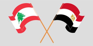 Crossed and waving flags of Lebanon and Egypt