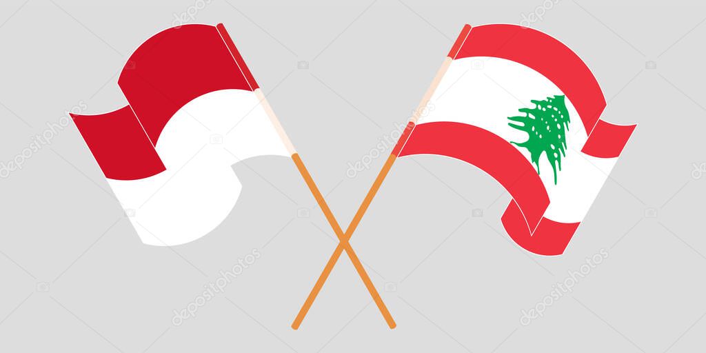 Crossed and waving flags of Lebanon and Indonesia