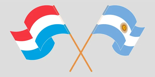 跨越并挥动卢森堡和阿根廷的国旗 — 图库矢量图片