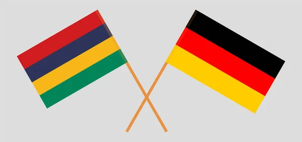 Overgestoken en wapperende vlaggen van Mauritius en Duitsland — Stockvector