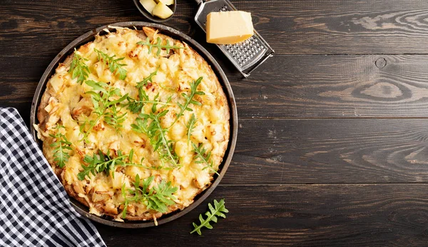 fresh homemade hawaiian pizza on black rustic table background