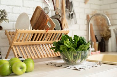 Preparing healthy foods. Healthy eating and dieting. fresh spinash in a bowl in the kitchen. Closeup of spinach