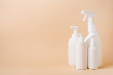 Eco friendly shopping and living.Group of white blank packaging tubes and containers for cosmetics on beige natural color background, mockup design, eco friendly