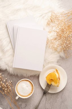 blank calendar mockup with carrot cake dessert, coffee and flowers on white rug