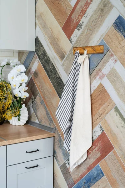 Interior of kitchen in rustic style with towels on hanger