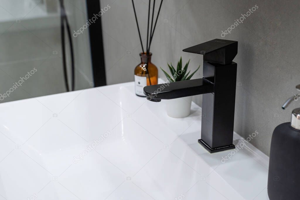 Large mirror over vessel sink in stylish bathroom interior