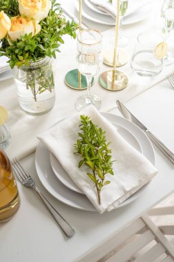 Wedding table set up in taditional style with roses grass and greenery. Wedding table scapes
