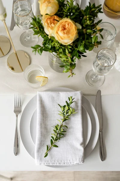 Wedding table set up in taditional style with roses grass and greenery. Wedding table scapes, top view table setting