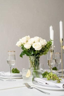 Wedding table set up in taditional style with roses grass and greenery. Wedding table scapes