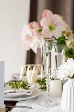 The wedding table setting and decor on wooden table in rustic style. Wedding table scapes. Table set up with boxwood and amaryllis flowers