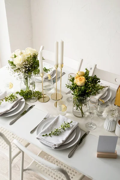 Wedding table set up in taditional style with roses and greenery. Wedding table scapes, high angle view table setting