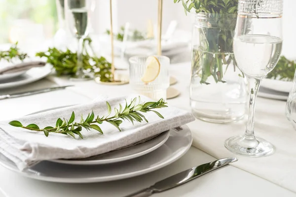 Wedding table set up in taditional style with roses and greenery. Wedding table scapes, front view table setting