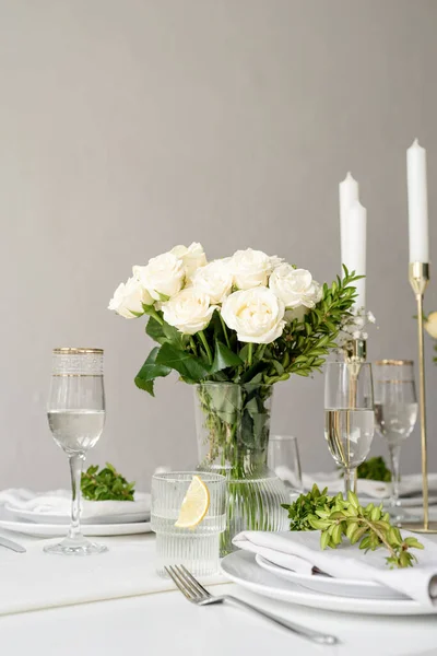 Wedding table set up in taditional style with roses grass and greenery. Wedding table scapes
