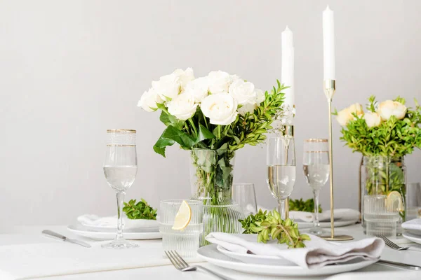 Wedding table set up in taditional style with roses grass and greenery. Wedding table scapes