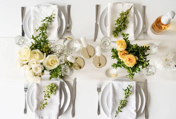 Wedding table set up in taditional style with roses grass and greenery. Wedding table scapes