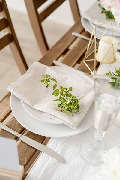 The wedding table setting and decor on wooden table in rustic style. Wedding table scapes. Table set up with boxwood and amaryllis flowers