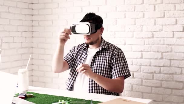 Young man using virtual reality glasses making renewable energy project dummy — 图库视频影像