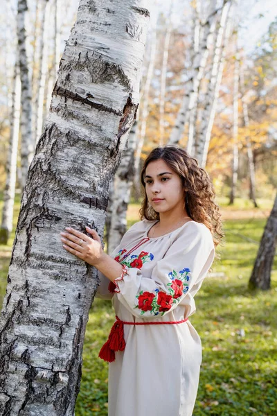 Indigenous people. beautiful woman in national ukrainian national traditional costume clothes walking in forest