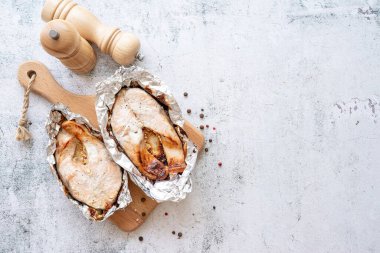 Grilled salmon steak with spices on concrete background. Top view