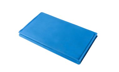 Pet care. Blue folded pet cooling mat or rug isolated on white background with clipping path, summer heat, copy space