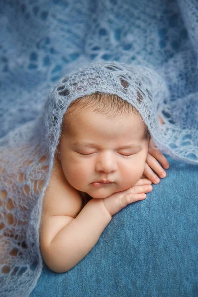 Bebê recém-nascido adormecido em um fundo azul coberto por cobertor. — Fotografia de Stock