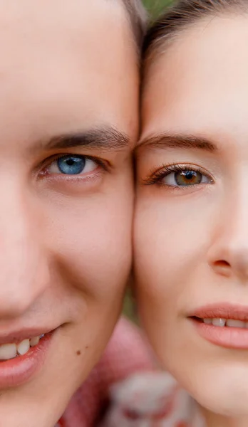 Close up portrait of man and woman. Face to face, half face. Male has blue eye and female has green eye. Genetics, generation concept.