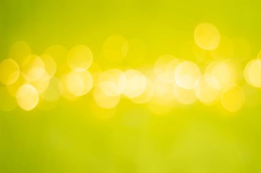 a strip of defocused yellow lights in the middle of a green background