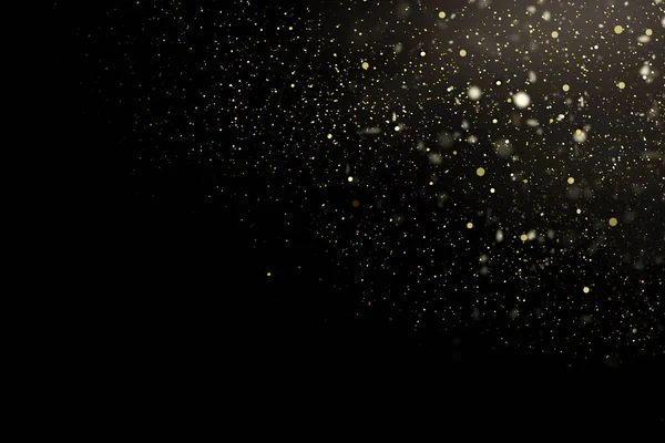yellow blurred glitter on dark background