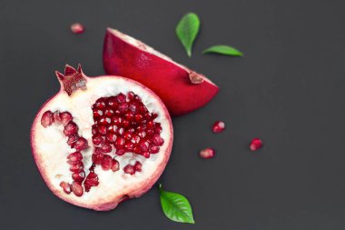 cut pomegranate on a black background close up