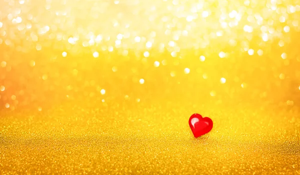 red heart on gold glitter background