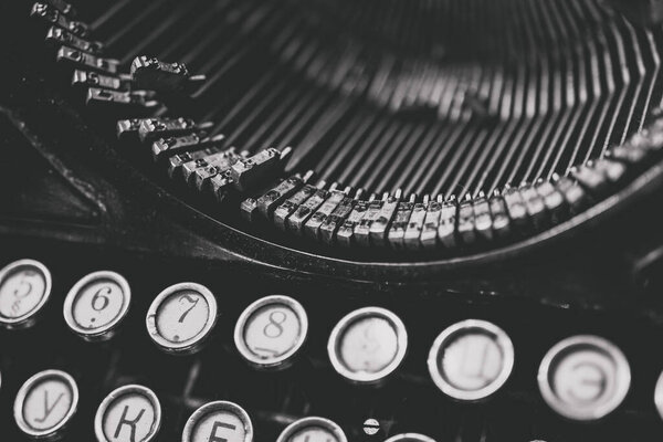 Letters and numbers on the keys of an old typewriter for typing